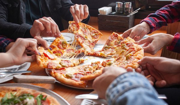 Friends sharing pizza